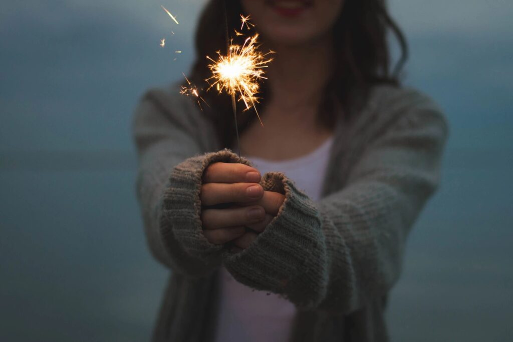 showing someone holding a sparkler